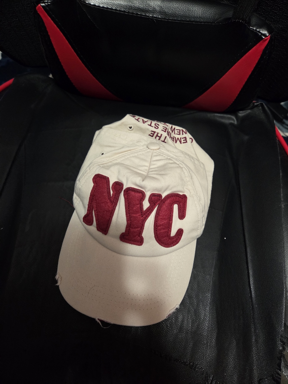 Embroidered Distressed NYC Baseball Cap in Cream with Red Lettering